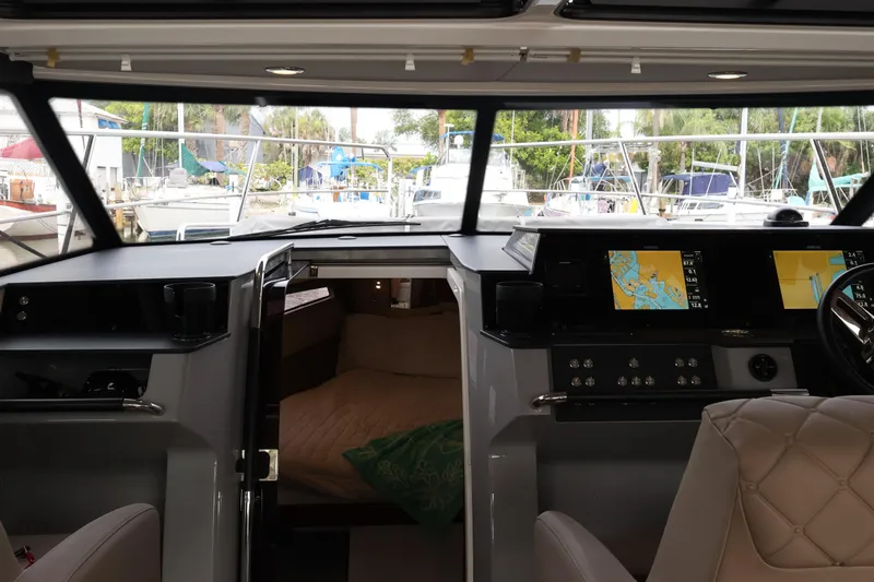 Slide: The Image of Interior view of 2024 Aquador 300 HT yacht cockpit with navigation screens. - 20