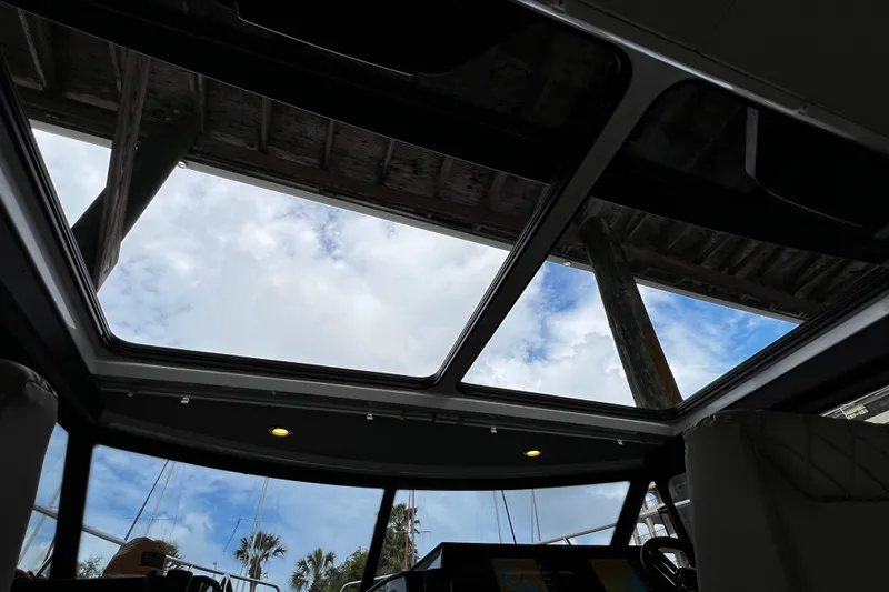 Slide: The Image of 2024 Aquador 300 HT interior view with skylight and cloudy sky. - 22