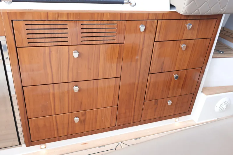 Slide: The Image of Wooden cabinetry on 2024 Aquador 300 HT boat, featuring sleek drawers and modern handles. - 27