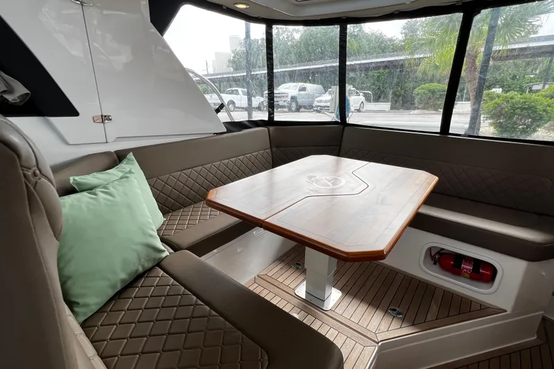 Slide: The Image of Luxurious interior of 2024 Aquador 300 HT boat with elegant seating and wooden table. - 40