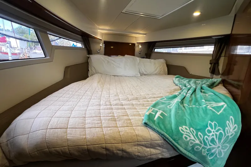 Slide: The Image of Cozy cabin interior of 2024 Aquador 300 HT with bed and windows. - 46