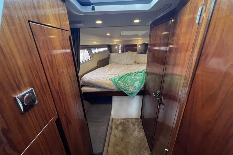 Slide: The Image of Luxurious cabin interior of 2024 Aquador 300 HT yacht with cozy bed and wooden finish. - 48