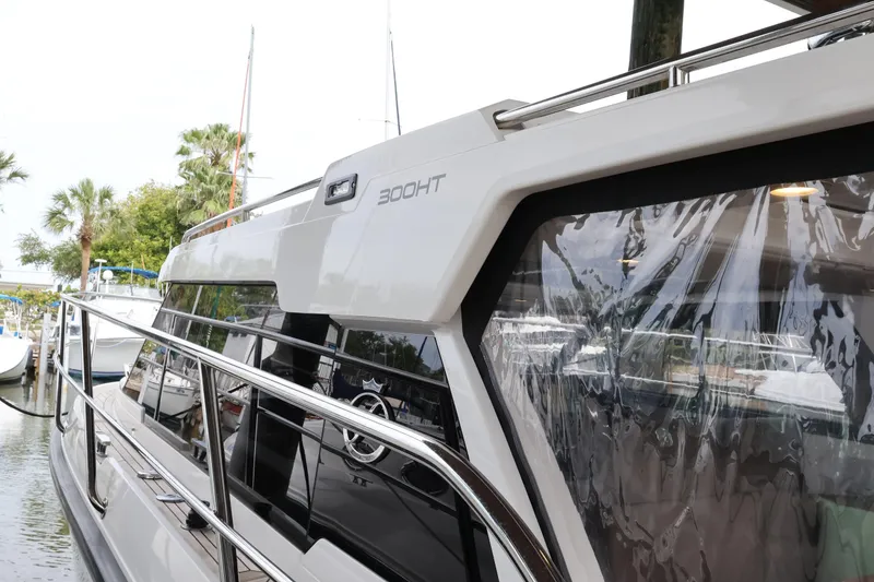 Slide: The Image of 2024 Aquador 300 HT yacht docked, showcasing sleek design and modern features. - 67