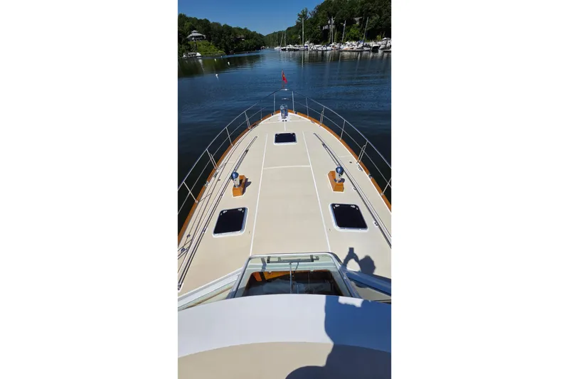 Slide: The Image of 2003 Grand Banks 49 Eastbay HX yacht deck view on a serene waterway. - 10