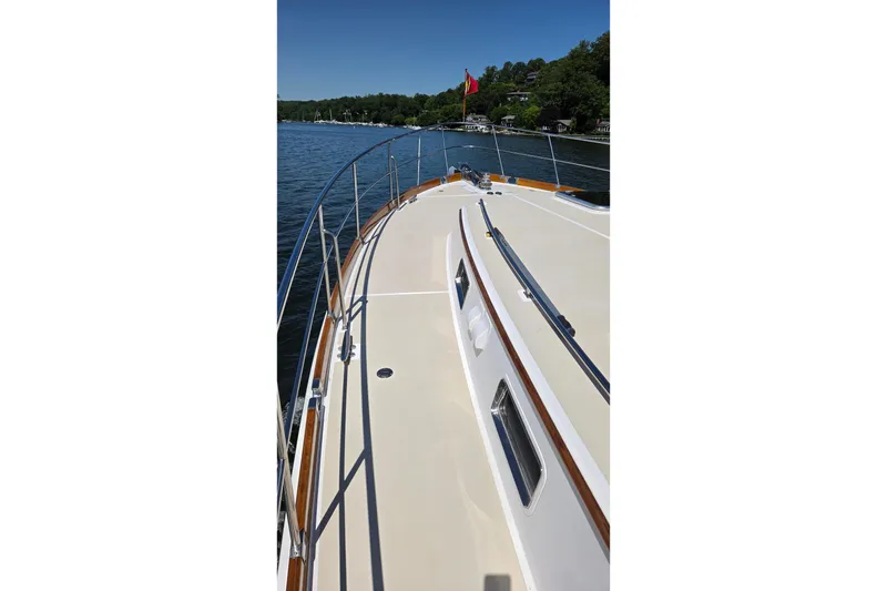 Slide: The Image of 2003 Grand Banks 49 Eastbay HX yacht deck with scenic water and shoreline view. - 12
