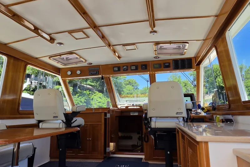Slide: The Image of Interior of 2003 Grand Banks 49 Eastbay HX yacht with elegant wood finish and helm seating. - 19