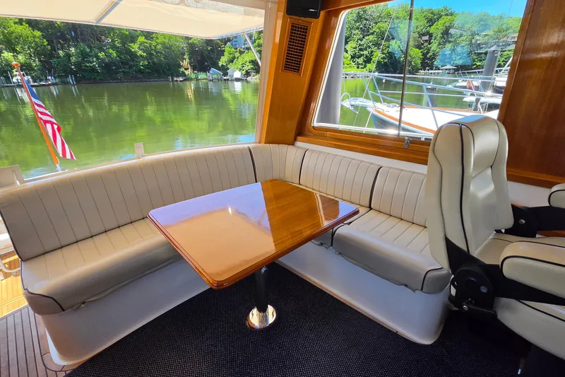 Slide: The Image of Luxurious 2003 Grand Banks 49 Eastbay HX yacht interior with elegant seating and scenic water view. - 20