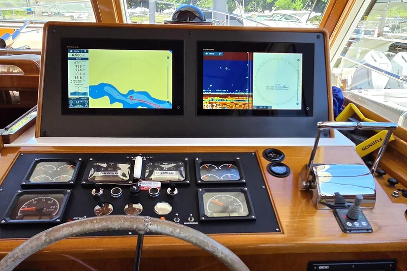 Slide: The Image of Helm of 2003 Grand Banks 49 Eastbay HX with navigation screens and controls. - 23