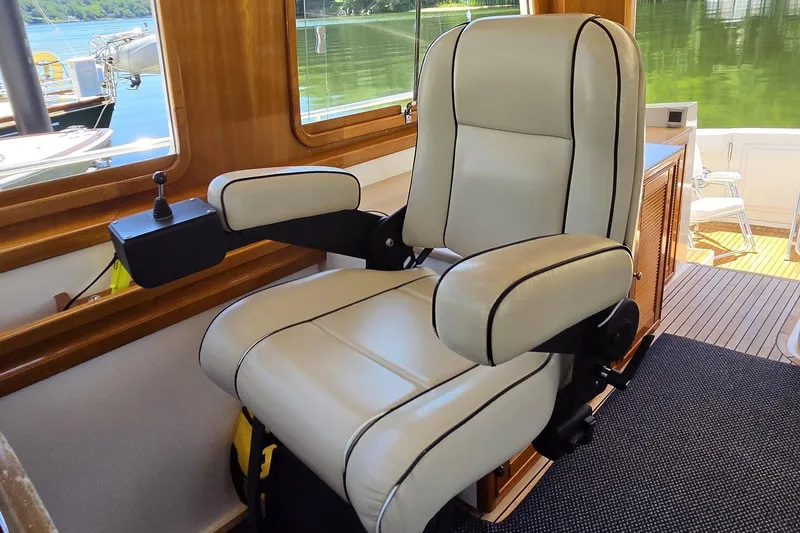 Slide: The Image of Luxurious captain's chair on 2003 Grand Banks 49 Eastbay HX yacht, featuring elegant leather upholstery. - 25