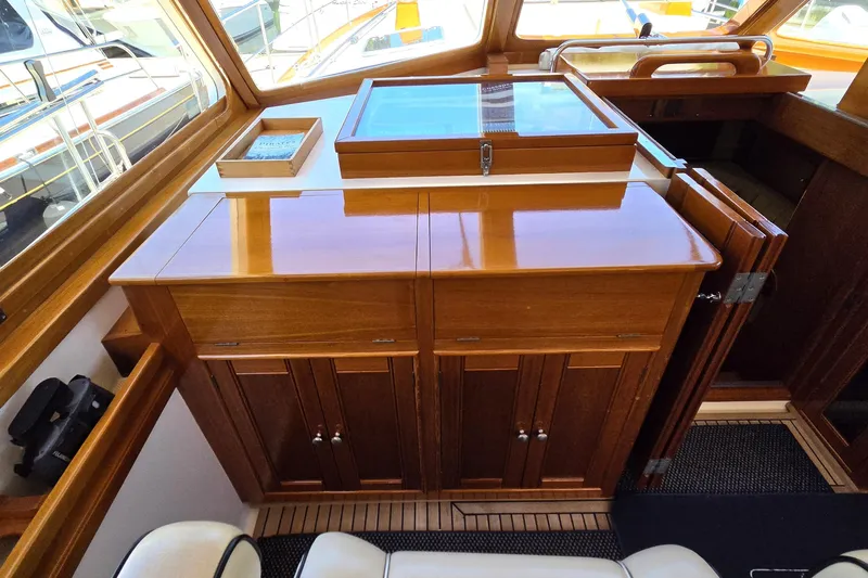 Slide: The Image of 2003 Grand Banks 49 Eastbay HX interior with polished wooden cabinetry and nautical decor. - 27