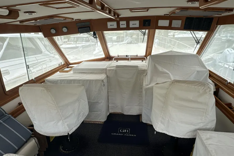 Slide: The Image of Interior of 2003 Grand Banks 49 Eastbay HX yacht with covered seating and helm. - 29