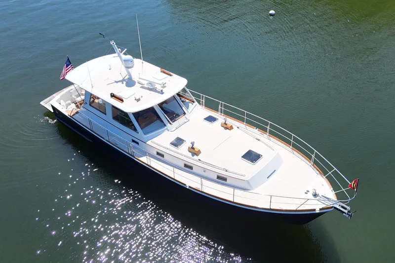 Slide: The Image of 2003 Grand Banks 49 Eastbay HX yacht on calm water, aerial view. - 3