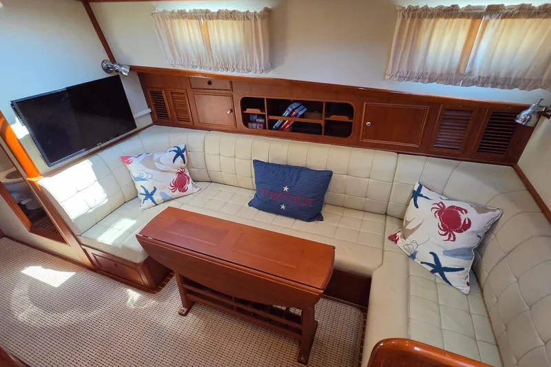 Slide: The Image of Luxurious 2003 Grand Banks 49 Eastbay HX yacht interior with cozy seating and nautical decor. - 30