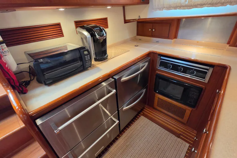 Slide: The Image of Luxurious 2003 Grand Banks 49 Eastbay HX yacht kitchen with modern appliances and wood cabinetry. - 32