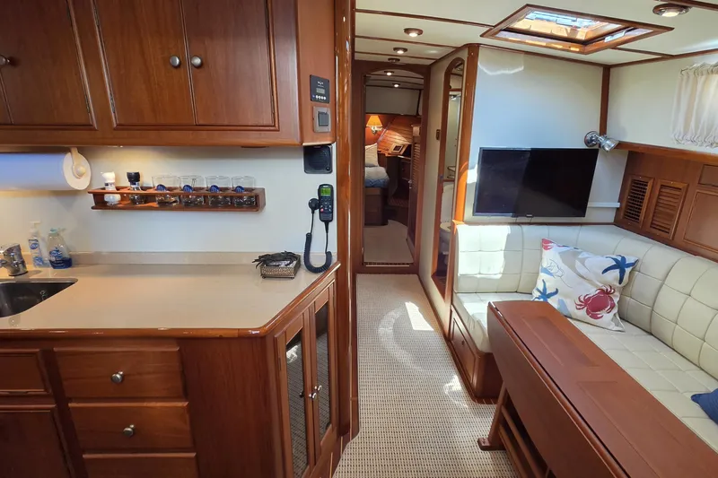 Slide: The Image of Luxurious 2003 Grand Banks 49 Eastbay HX yacht interior with cozy seating and elegant wood finishes. - 33