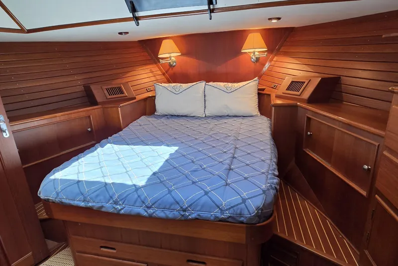 Slide: The Image of Luxurious cabin interior of 2003 Grand Banks 49 Eastbay HX with cozy bed and wooden finish. - 34