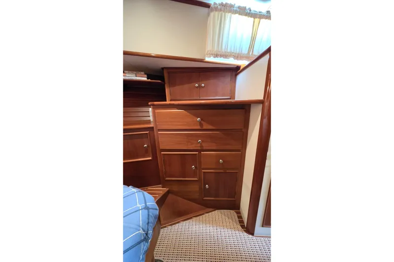 Slide: The Image of Wooden cabinetry inside 2003 Grand Banks 49 Eastbay HX yacht, featuring drawers and a cozy interior. - 35