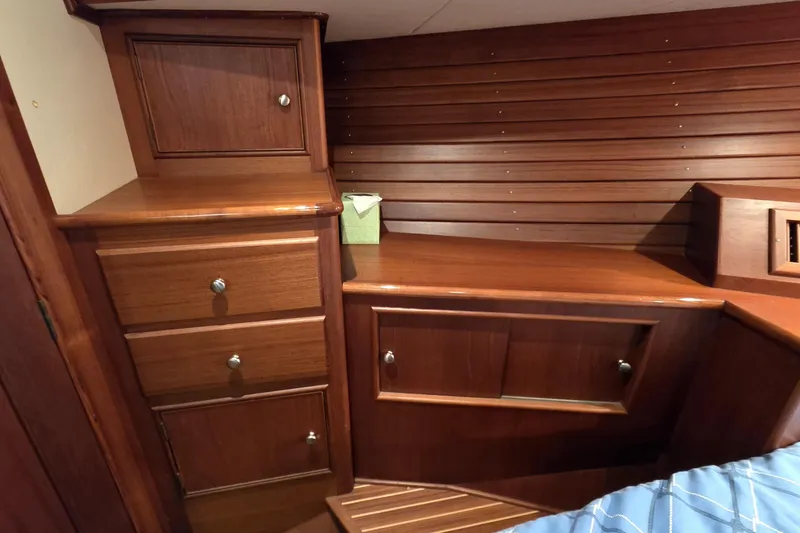 Slide: The Image of 2003 Grand Banks 49 Eastbay HX interior with elegant wooden cabinetry and drawers. - 36