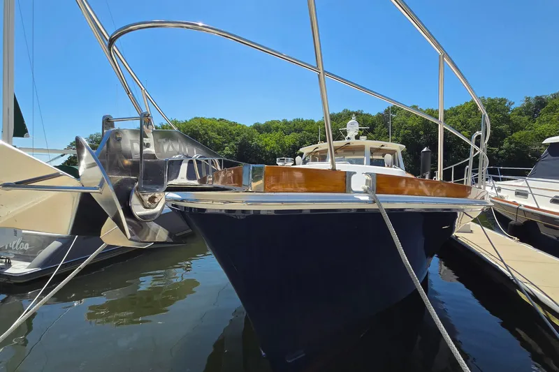 Slide: The Image of 2003 Grand Banks 49 Eastbay HX yacht docked at marina under clear blue sky. - 8