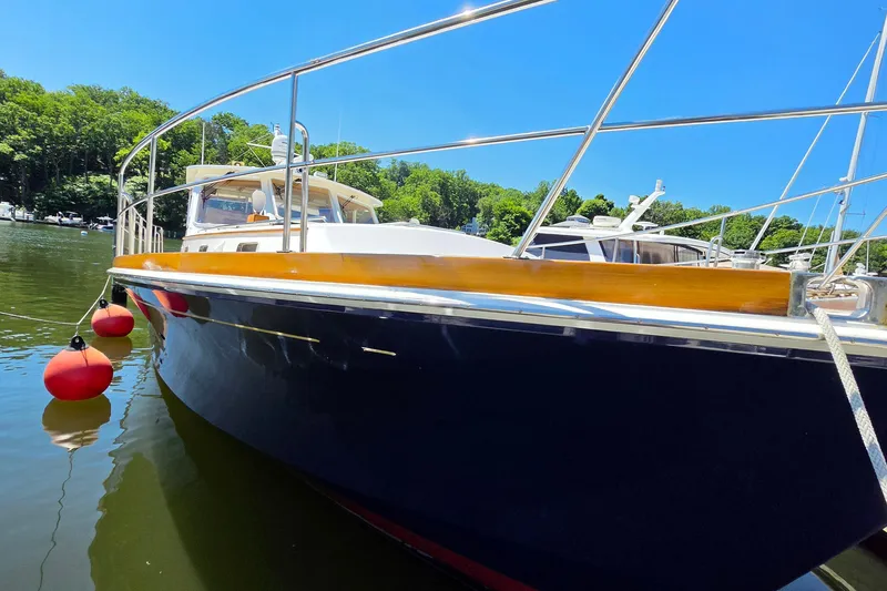 Slide: The Image of 2003 Grand Banks 49 Eastbay HX yacht docked on a sunny day with red buoys. - 9