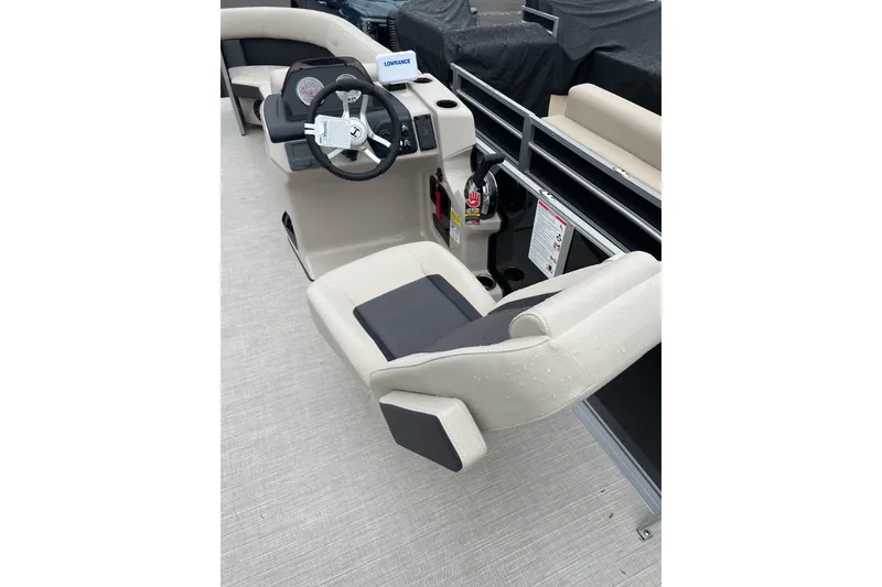 Slide: The Image of 2026 Harris Cruiser 230 SL boat interior with steering console and beige seating. - 2