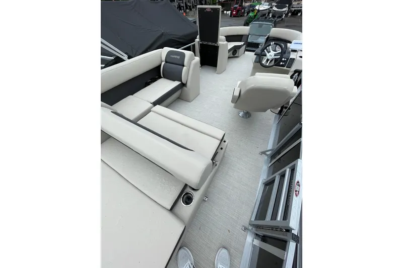 Slide: The Image of 2026 Harris Cruiser 230 SL pontoon boat interior with beige seating and modern helm. - 5