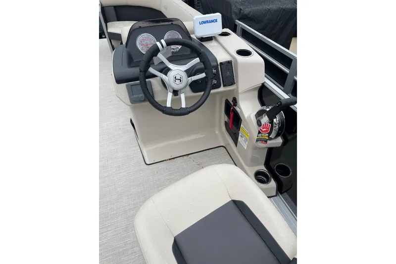 Slide: The Image of 2026 Harris Cruiser 230 SL boat cockpit with steering wheel and control panel. - 7