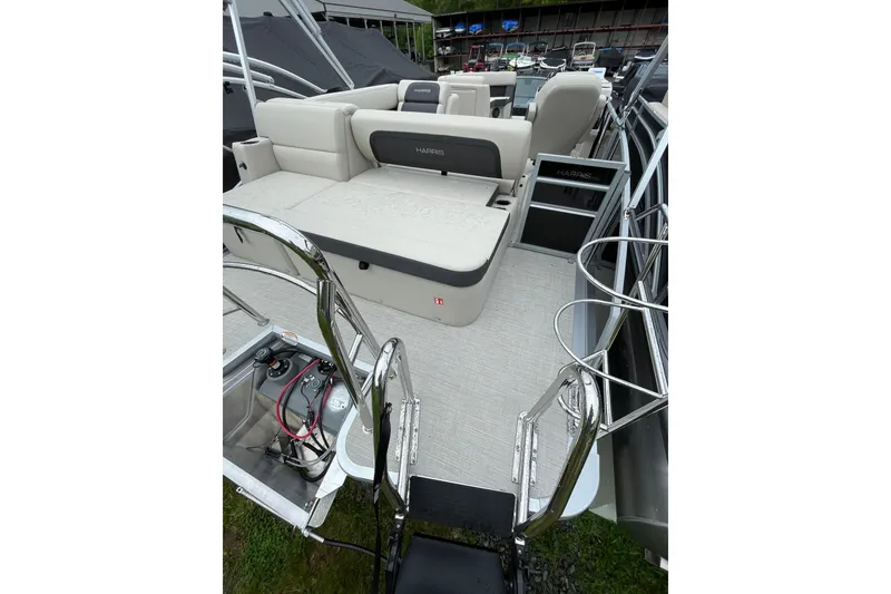Slide: The Image of 2026 Harris Cruiser 230 SL pontoon boat interior with seating and ladder. - 9