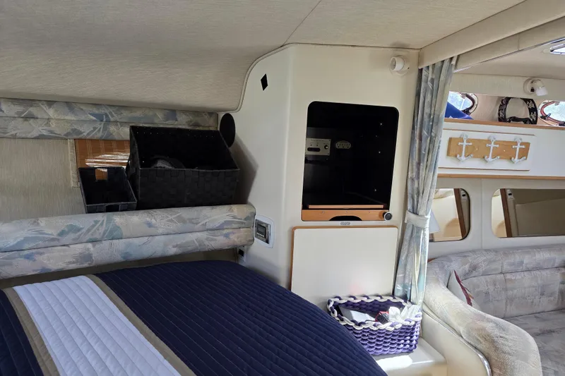 Slide: The Image of Interior of 1994 Sea Ray 370 Express Cruiser with cozy seating and storage baskets. - 15