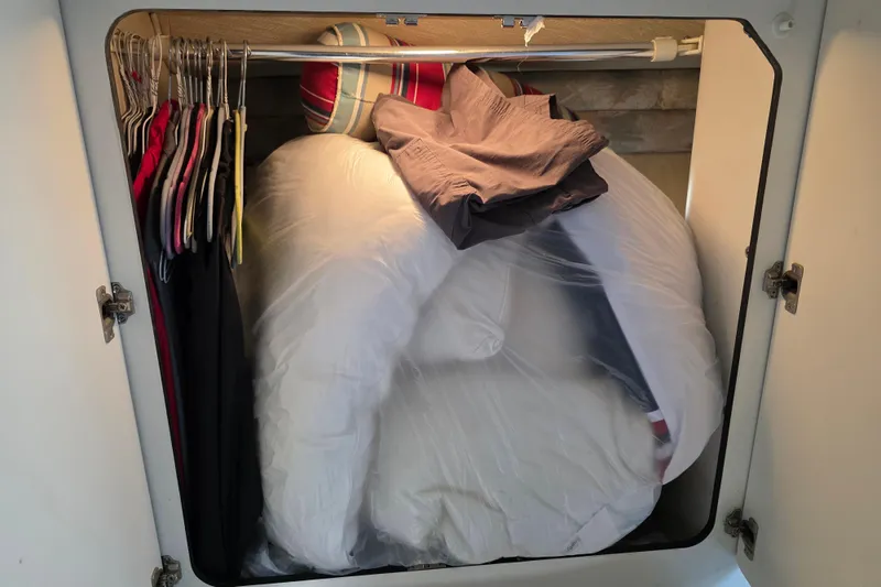 Slide: The Image of Closet in 1994 Sea Ray 370 Express Cruiser with clothes and bedding storage. - 18