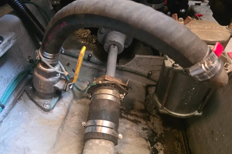 Slide: The Image of Engine compartment of a 1994 Sea Ray 370 Express Cruiser, showing hoses and mechanical components. - 29