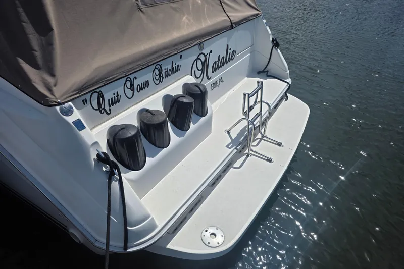 Slide: The Image of 1994 Sea Ray 370 Express Cruiser with custom name, docked on calm water. - 4