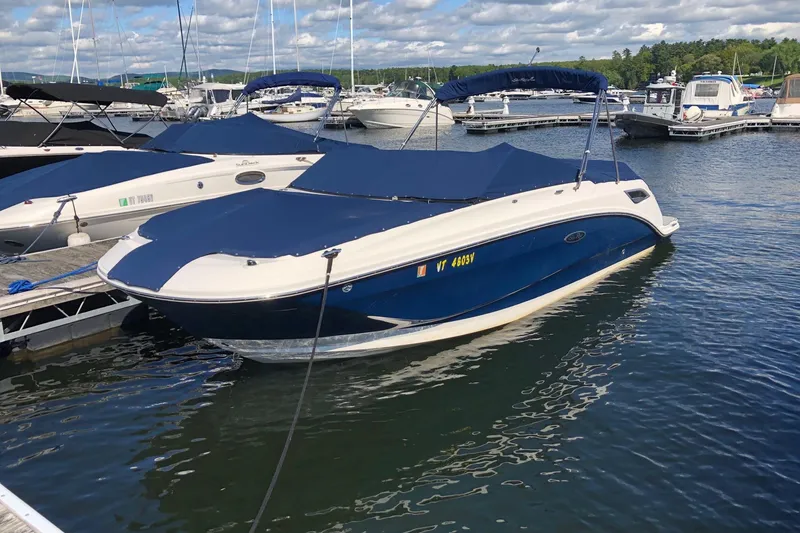 The Image of 2013 Sea Ray 270 Select EX boat docked at marina, covered with blue canopy. - 1