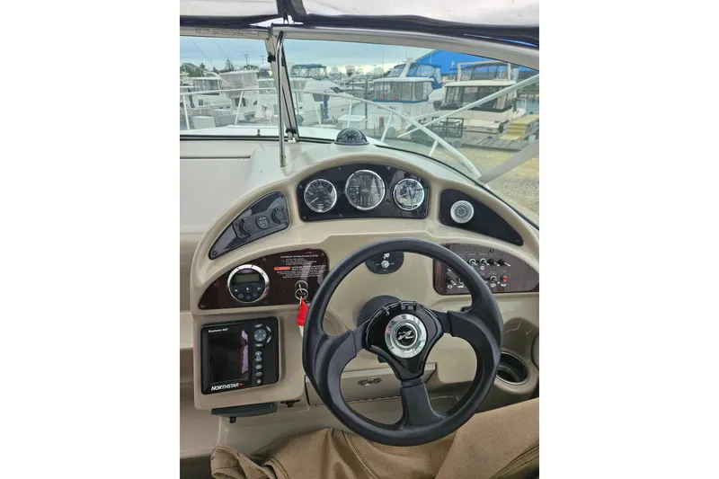 Slide: The Image of Steering console of a 2007 Sea Ray 270 Sundancer boat with gauges and controls. - 10