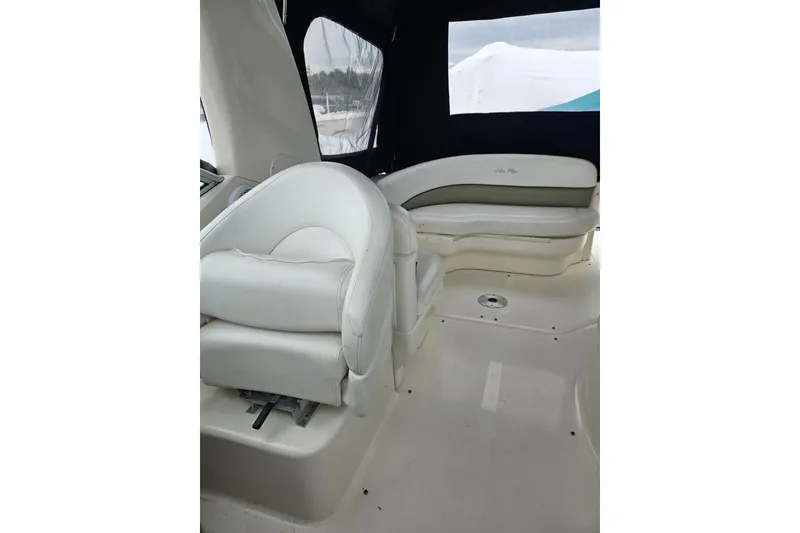 Slide: The Image of Interior of 2007 Sea Ray 270 Sundancer boat with white seating and dark canopy. - 11