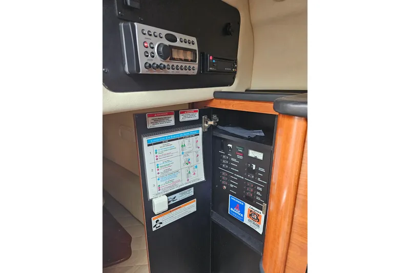 Slide: The Image of 2007 Sea Ray 270 Sundancer cabin control panel with radio and electrical switches. - 12