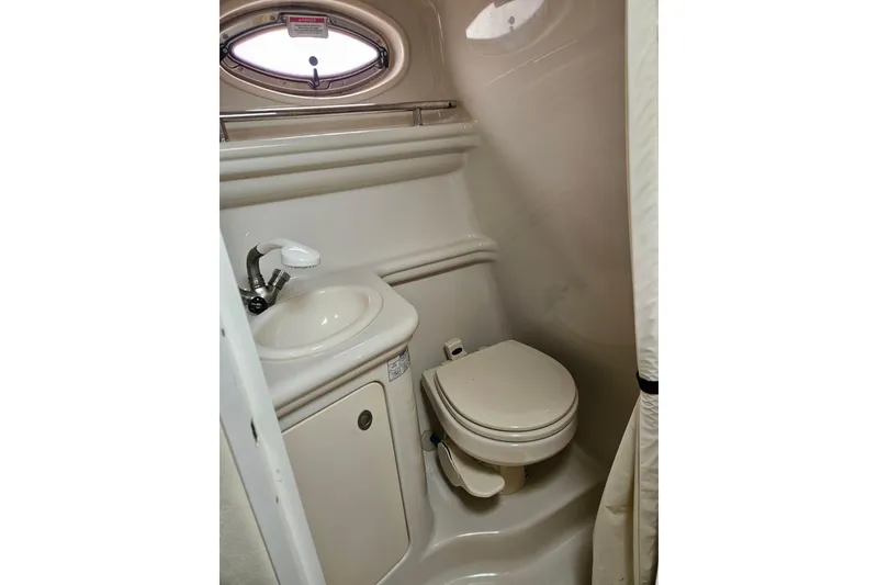 Slide: The Image of Compact bathroom in 2007 Sea Ray 270 Sundancer boat, featuring sink and toilet. - 13
