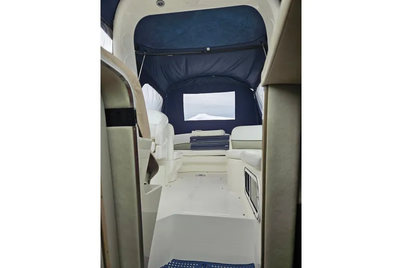 Slide: The Image of Interior view of 2007 Sea Ray 270 Sundancer boat with seating and blue canopy. - 4
