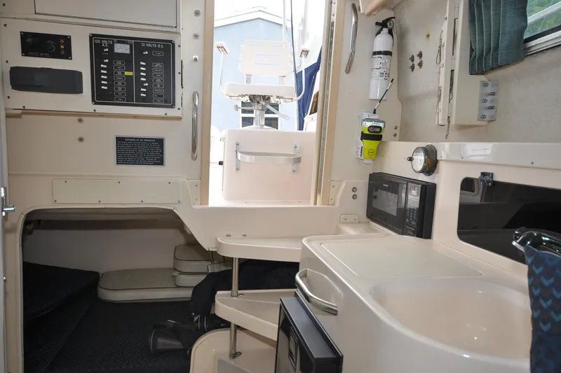Slide: The Image of 1997 Grady-White Marlin 300 cabin interior with kitchenette and control panel. - 11