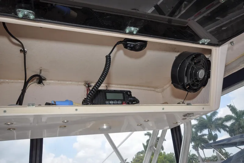 Slide: The Image of 1997 Grady-White Marlin 300 boat interior with radio and fan in storage compartment. - 14