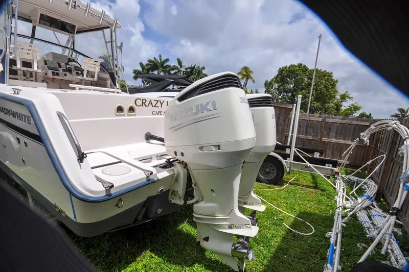 Slide: The Image of 1997 Grady-White Marlin 300 boat with Suzuki outboard motors on grassy yard. - 20
