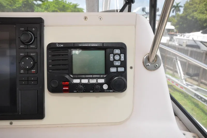 Slide: The Image of 1997 Grady-White Marlin 300 boat dashboard with Icom VHF marine radio. - 23