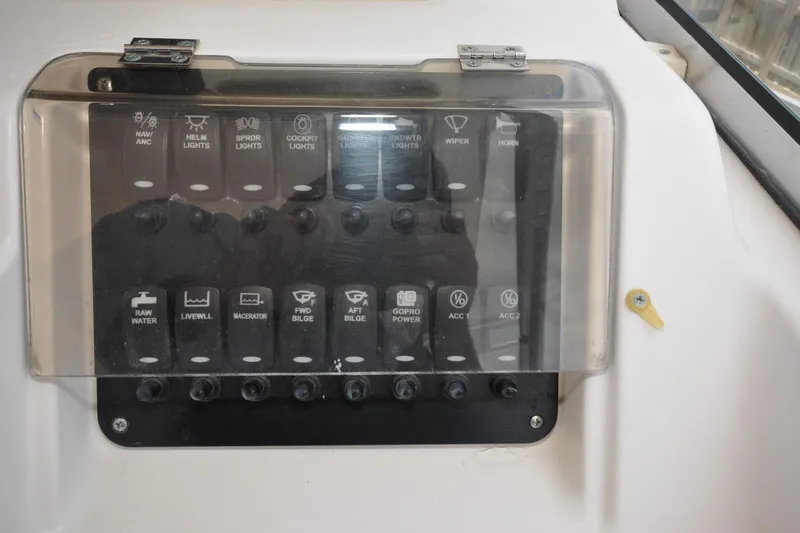 Slide: The Image of Control panel of a 1997 Grady-White Marlin 300 boat with labeled switches. - 25