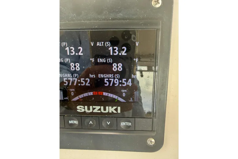 Slide: The Image of Suzuki engine display on 1997 Grady-White Marlin 300 boat, showing voltage and engine hours. - 26