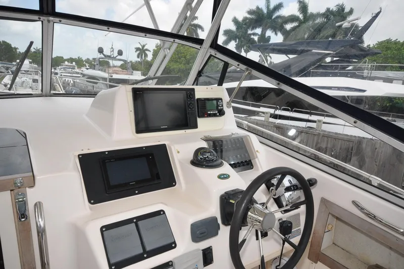 Slide: The Image of Helm of 1997 Grady-White Marlin 300 boat with navigation equipment and steering wheel. - 4