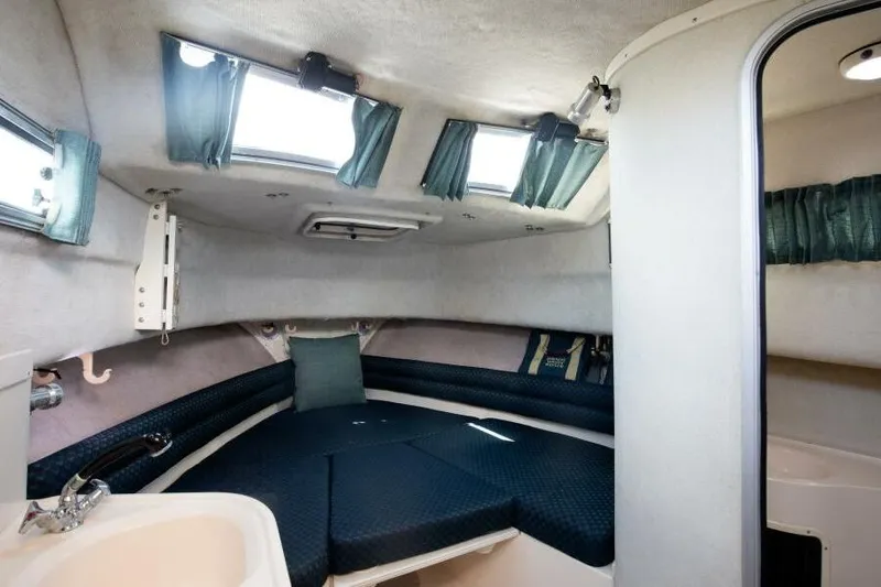 Slide: The Image of Interior cabin of a 1997 Grady-White Marlin 300 boat with blue seating and windows. - 7