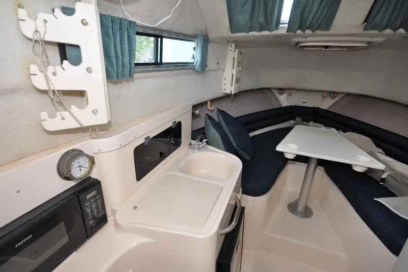 Slide: The Image of Interior of a 1997 Grady-White Marlin 300 boat with kitchenette and seating area. - 8