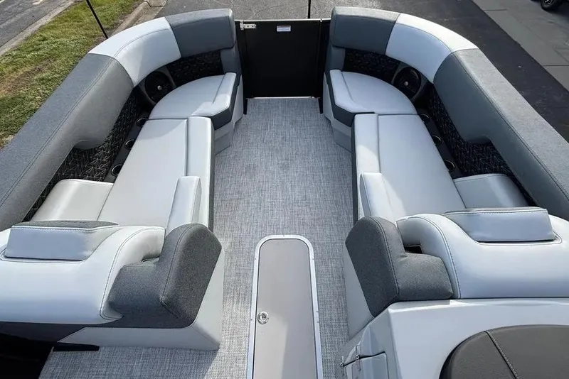 Slide: The Image of 2026 Alera M25L boat interior with gray seating and carpeted flooring. - 10