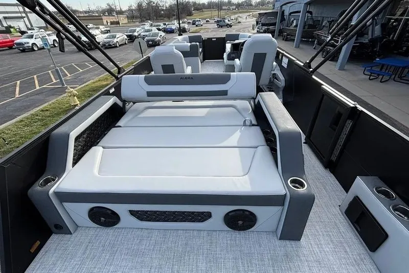 Slide: The Image of 2026 Alera M25L boat interior with gray seating and cup holders. - 12