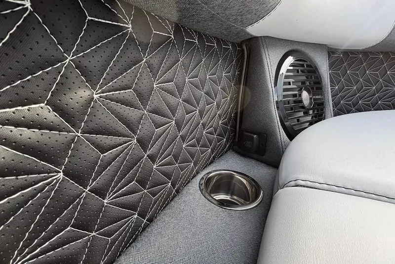 Slide: The Image of Luxurious interior of 2026 Alera M25L with quilted leather and speaker detail. - 2